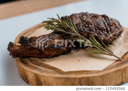 Pork steak with sauce on a wooden board 115450568