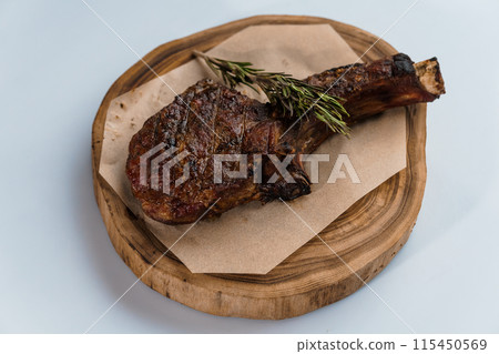 Pork steak with sauce on a wooden board 115450569