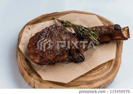 Pork steak with sauce on a wooden board 115450570