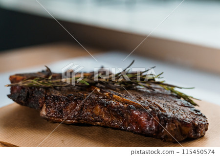 Pork steak with sauce on a wooden board 115450574