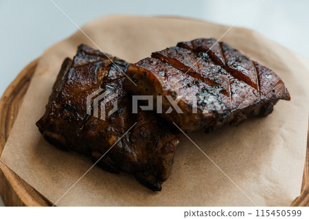Pork steak with sauce on a wooden board Pork steak with sauce on a wooden board 115450599