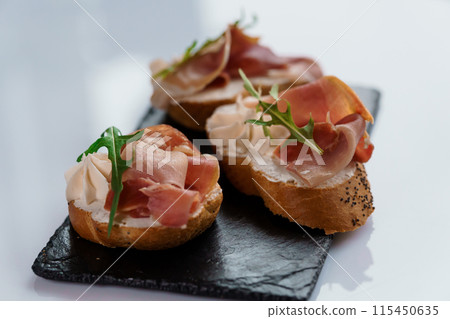 Canapes with sun-dried tomato and salami Canapes with sun-dried tomato and salami 115450635