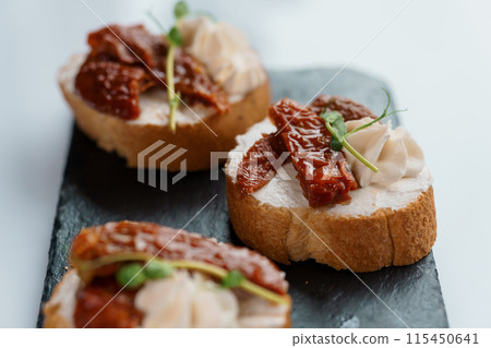Canapes with sun-dried tomato and salami Canapes with sun-dried tomato and salami 115450641