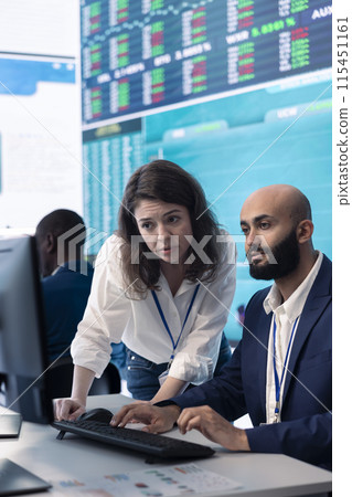 Team of investors analyzing profit amount and making decisions to fund another business project, examine big data on a huge display. Associates verifying efficiency and budget. Team of investors analyzing profit amount and making decisions to fund another business project, examine big data on a huge display. Associates verifying efficiency and budget. 115451161