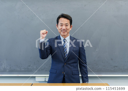 A teacher giving a fist pump at the podium A teacher giving a fist pump at the podium 115451699