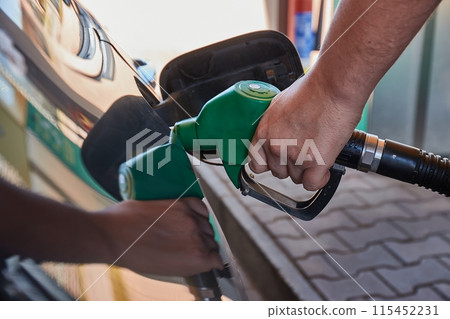 Fuel station nozzle filling car tank Fuel station nozzle filling car tank 115452231