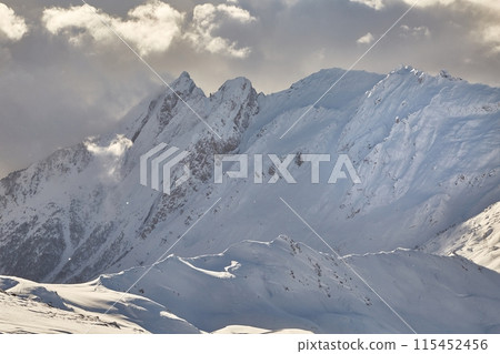 Winter high mountains in clouds 115452456