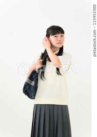 A high school girl in summer clothes holding a bag A high school girl in summer clothes holding a bag 115453300
