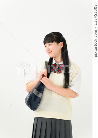 A high school girl in summer clothes holding a bag 115453305