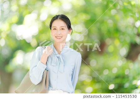 Business woman smiling in the fresh green 115453530