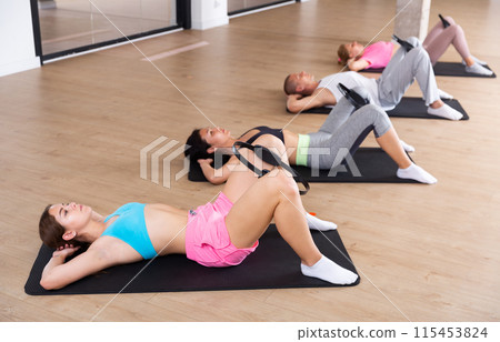 Group of adults exercising with pilates ring Group of adults exercising with pilates ring 115453824