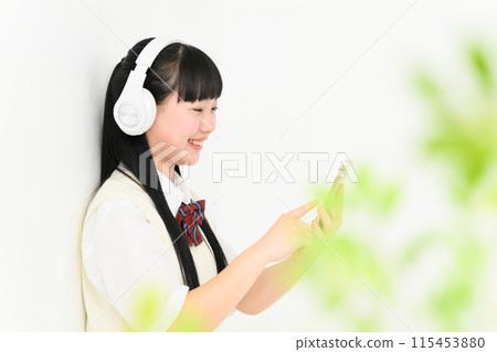 High school girl listening to music, headphones High school girl listening to music, headphones 115453880