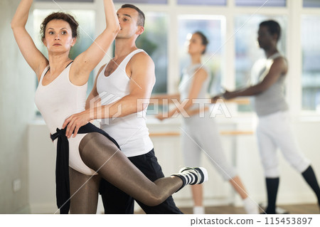 Man and girl woman together arabesque position of ballet during choreography studio Man and girl woman together arabesque position of ballet during choreography studio 115453897