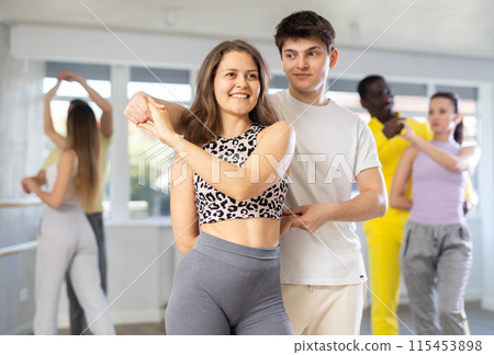 Ordinary adults dancing bachata together in dance studio 115453898