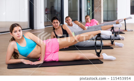 Young sporty woman exercising with pilates ring Young sporty woman exercising with pilates ring 115453954