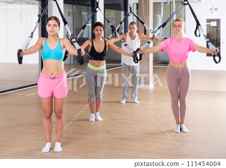 People training trx pilates at group class 115454004