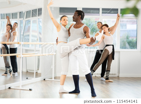 Adult man and young woman rehearsing pair ballet 115454141