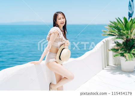 A woman in a swimsuit enjoying vacation at a resort 115454179