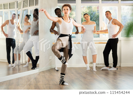 Ballerina dances dance at rehearsal in choreographic studio Ballerina dances dance at rehearsal in choreographic studio 115454244