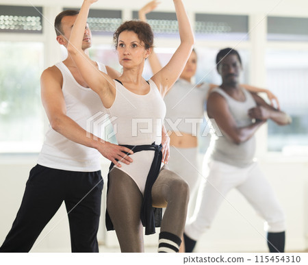 Young man and adult woman rehearsing pair ballet 115454310