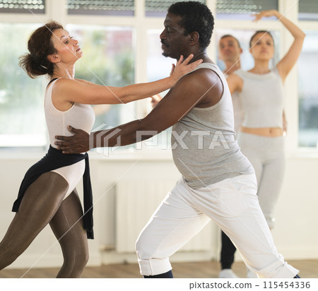 Adult man and adult woman rehearsing pair ballet Adult man and adult woman rehearsing pair ballet 115454336
