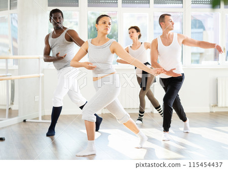 Asian woman enjoying ballet practice with group of amateurs 115454437