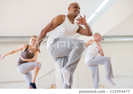 Man dancing at group lesson in studio Man dancing at group lesson in studio 115454477