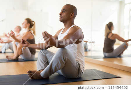 Positive people relaxing and enjoying yoga Positive people relaxing and enjoying yoga 115454492