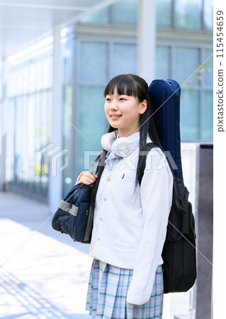 High school girl carrying a guitar 115454659