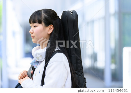 High school girl carrying a guitar 115454661