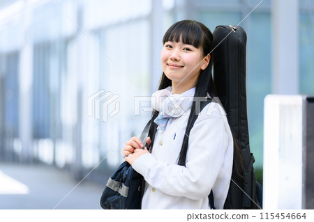 High school girl carrying a guitar 115454664
