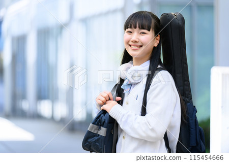 High school girl carrying a guitar 115454666