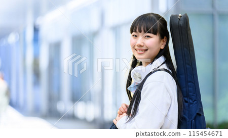 High school girl carrying a guitar 115454671