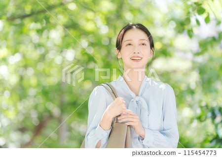 Business woman walking in fresh green Business woman walking in fresh green 115454773