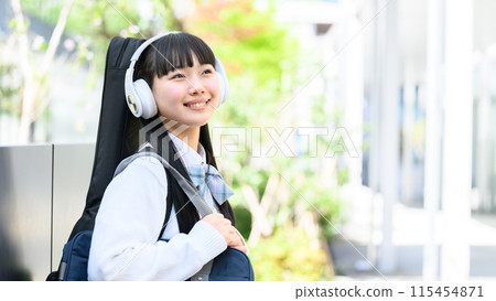 High school girl carrying guitar, smartphone High school girl carrying guitar, smartphone 115454871