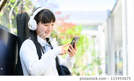 High school girl carrying guitar, smartphone 115454875