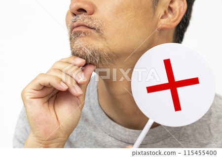 A bearded man holding a plaque on a white background A bearded man holding a plaque on a white background 115455400