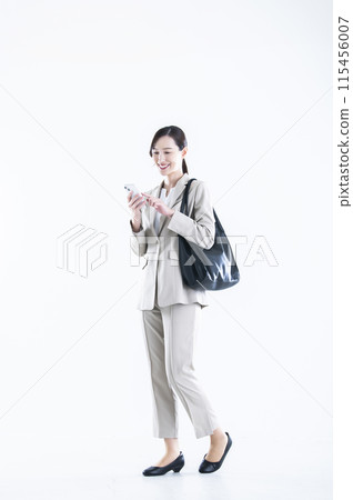 Business woman operating a smartphone 115456007