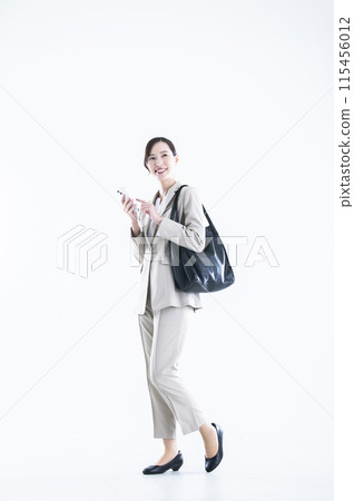 Business woman operating a smartphone Business woman operating a smartphone 115456012