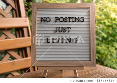 NO POSTING JUST LIVING text on letter board on background of greenery garden. Concept of social media technology detox. Farmcore nature core slow life NO POSTING JUST LIVING text on letter board on background of greenery garden. Concept of social media technology detox. Farmcore nature core slow life 115456152