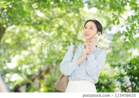 A woman calling in the fresh green 115456610