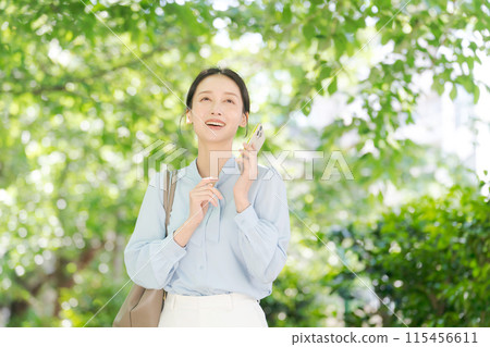 A woman calling in the fresh green 115456611