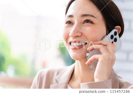 Young woman talking on smartphone Business image Young woman talking on smartphone Business image 115457286