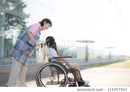 A child in a wheelchair and caregivers and nurses who provide care and assistance, whole body 115457503