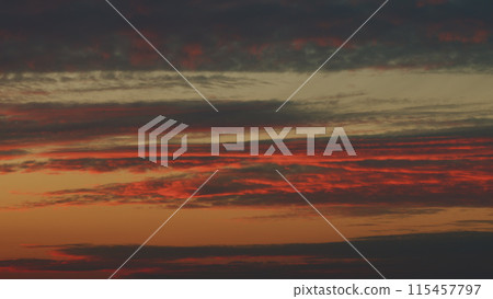 Sunset or dawn backlit by warm sun. Panorama style background. Sunset or dawn sky. Timelapse. 115457797
