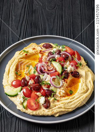 Greek hummus with veggies, olives, feta on plate 115457896