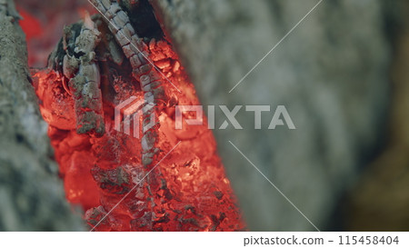 Camp fire burning. Hot coals in different shades of red. Slow motion. Camp fire burning. Hot coals in different shades of red. Slow motion. 115458404