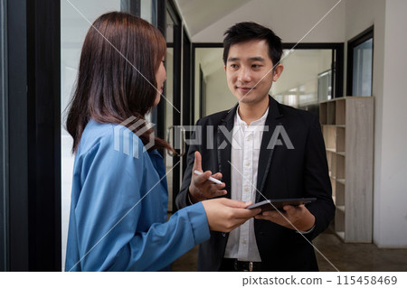 Business Team Discuss Analysis in Modern Office Setting with Digital Tablet and Professional Attire 115458469