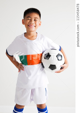 Portrait Asian smiling young boy kids wear uniform holding and posing with soccer ball studio shot isolated white background, cute child playing football sport hobby for kids, leisure games concept 115458478