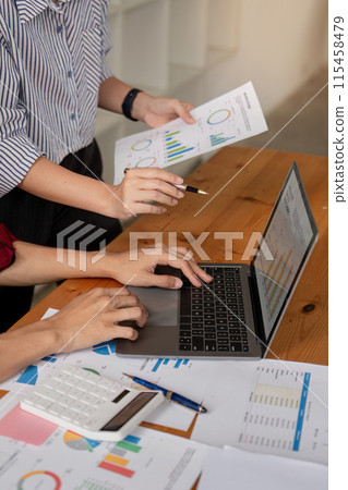 Business Team Collaboration on Data Analysis with Charts and Graph in Modern Office Setting 115458479